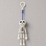 Mr. Bones pull-cord dancing skeleton keychain on a clean white background