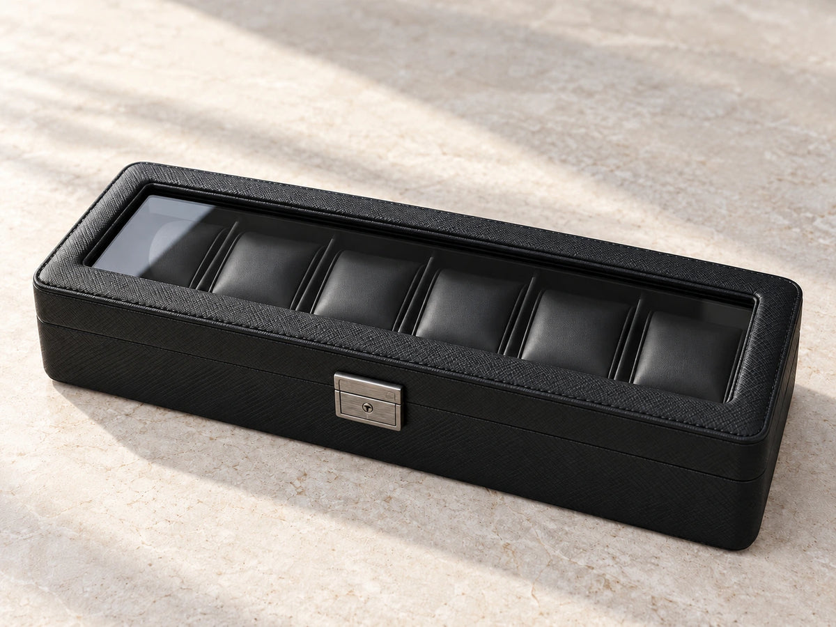 ARX6 all-black six-slot watch case, closed on a pale stone surface