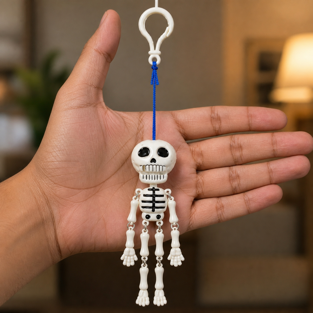 Mr. Bones skeleton keychain held in hand for scale